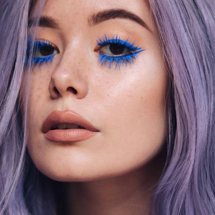 CLOSE UP SU VISO DI RAGAZZA CON OCCHI CASTANI CHE INDOSSA MASCARA COLORATI