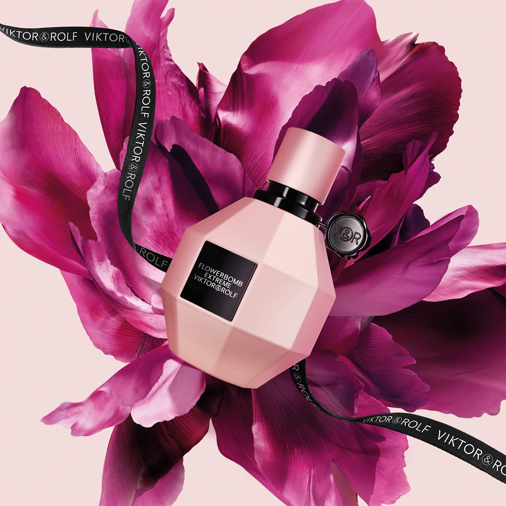 Flowerbomb Extrême – Viktor & Rolf posato su un fiore fucsia e un nastro nero con la scritta Viktor & Rolf