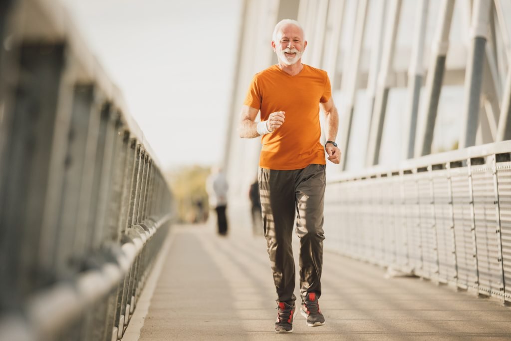 attività fisica per prevenire l'osteoporosi, uomo maturo che corre all'aperto