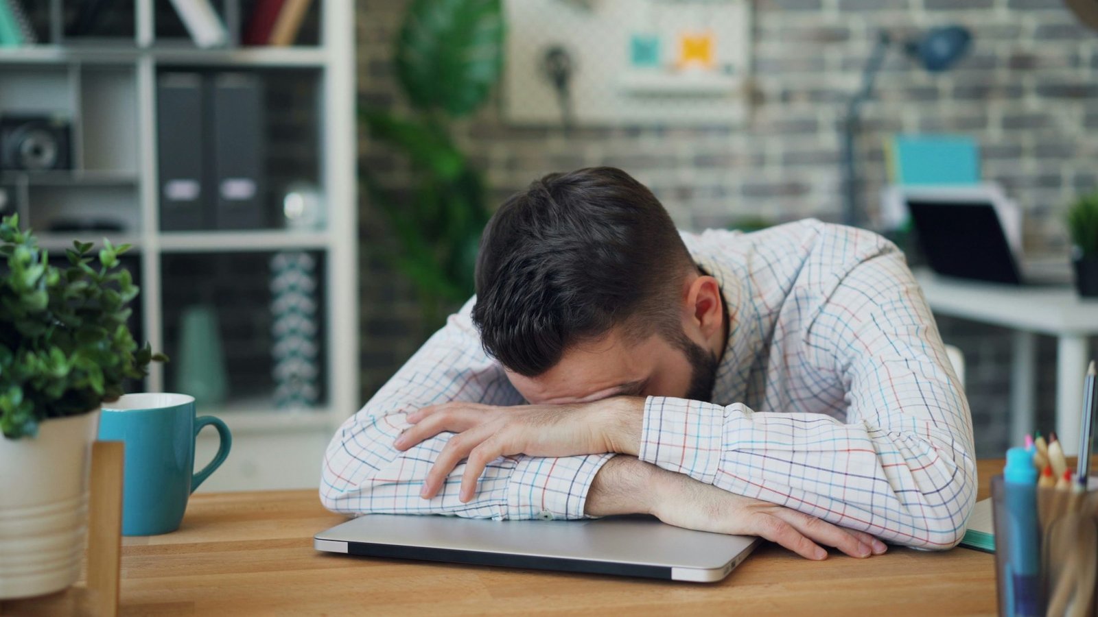 ragazzo stressato si accascia sul pc , stanco. 