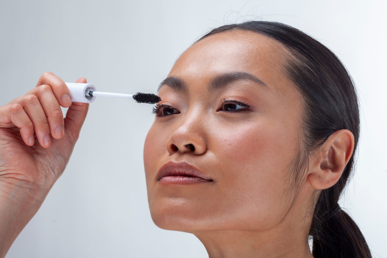 ragazza asiatica applica mascara - concetto di Mascara economici migliori 2026