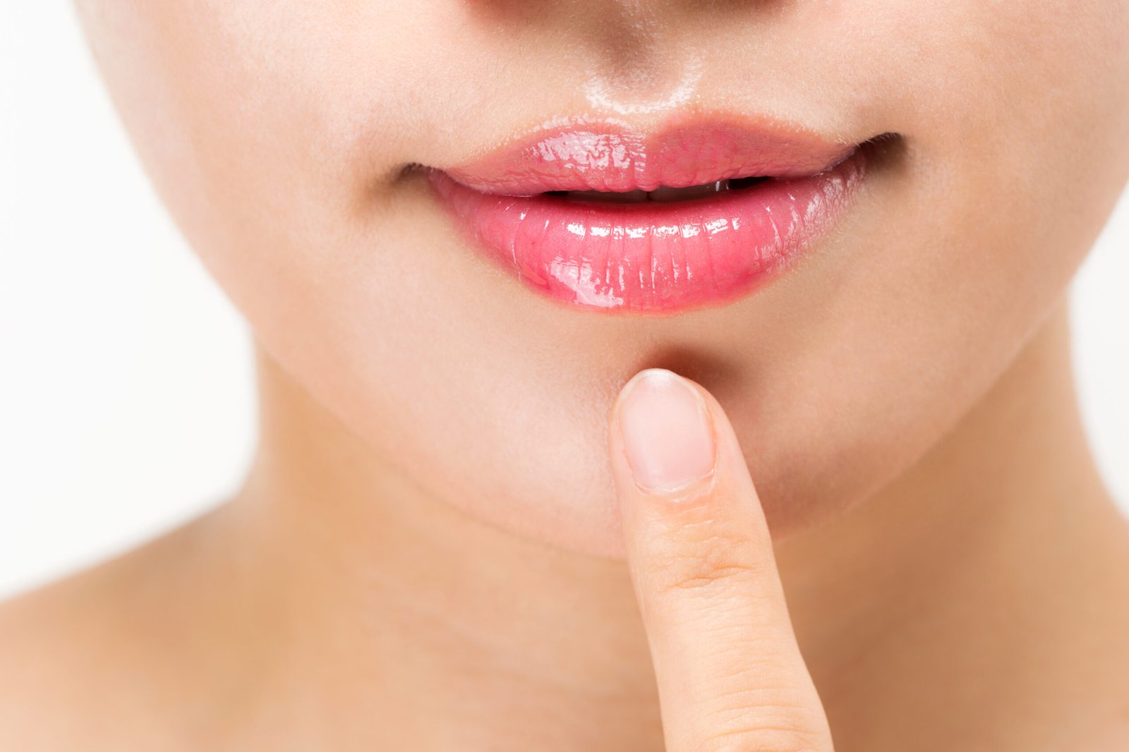 Concetto: come usare la vaselina per le labbra, Primo paino di labbra di giovane donna lucide e morbide
